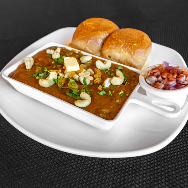 Honest Indian Restaurant's Pav Bhaji, a rich vegetable curry with butter, cashews, raisins, and two buns.